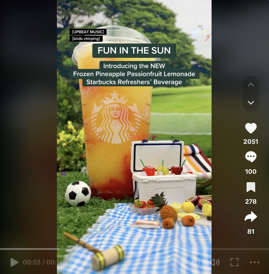 A Starbucks video on TikTok featuring a new drink. The drink is shown within a miniature picnic set.